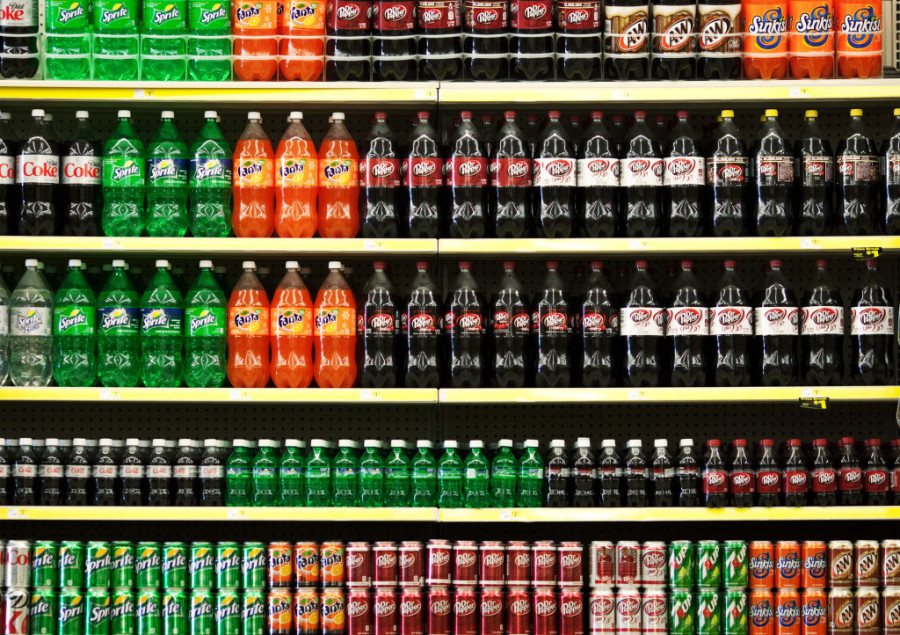 Soft drinks are displayed on the shelf at a Dollar General Corp. store in Saddle Brook, New Jersey, U.S., on Saturday, Dec. 3, 2011. Dollar General is scheduled to announce earnings results on Dec. 5. Photographer: Emile Wamsteker/Bloomberg via Getty Images