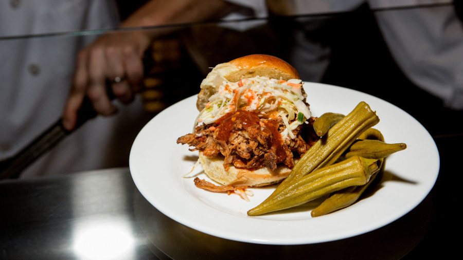 Lexington-style BBQ pork sandwich, served with slaw and pickled okra, one of the offerings of the Agricultural South section of the Sweet Home Cafe. The restaurant inside the National Museum of African American History and Culture has a menu designed to highlight the breadth of black contributions to the nation's cuisine.