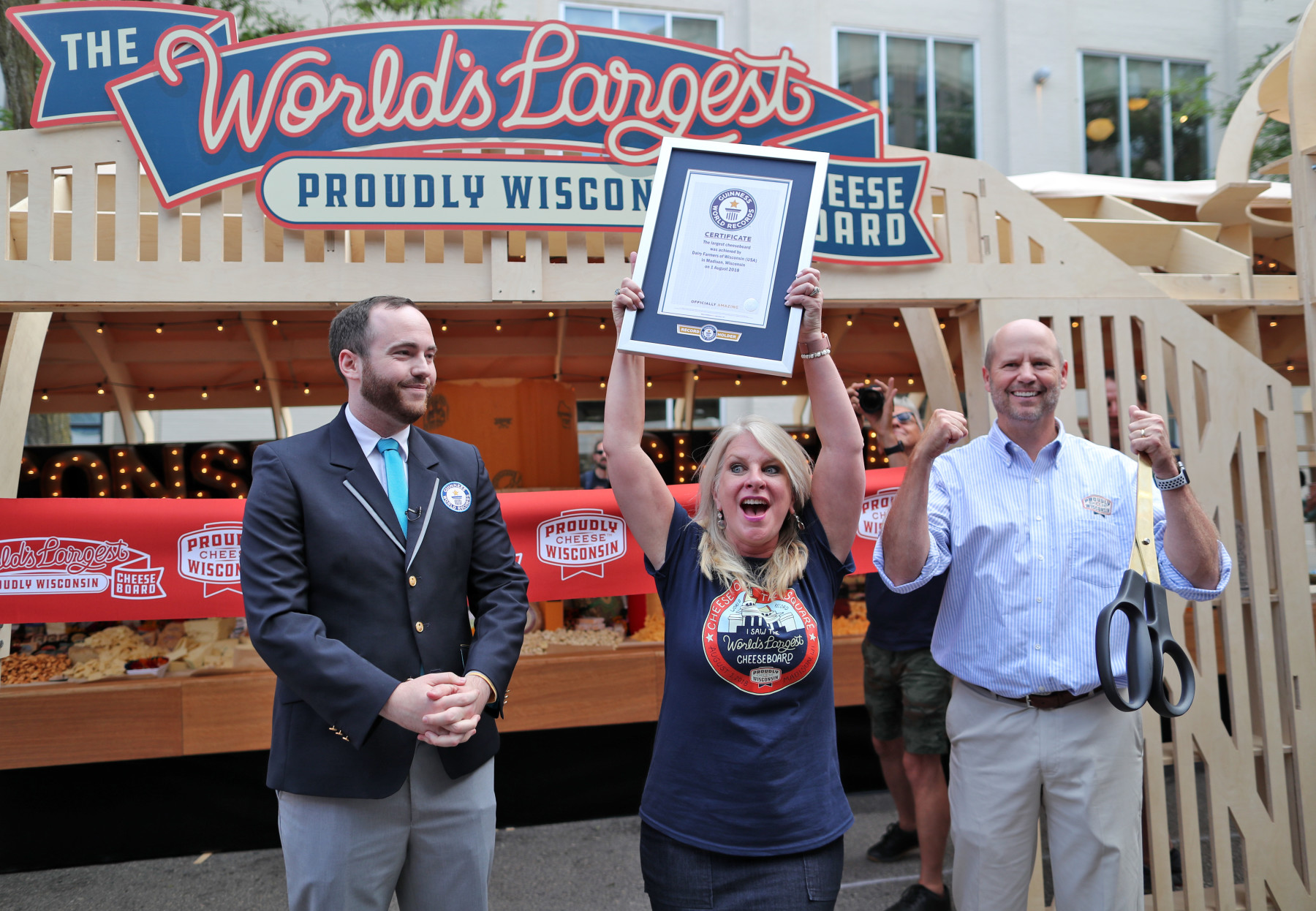 during a Guinness World Records winning attempt at the worlds largest cheeseboard in downtown Madison, Wis., on Wednesday, Aug. 1. The final weight of the cheese on the board came to 4,437 pounds.